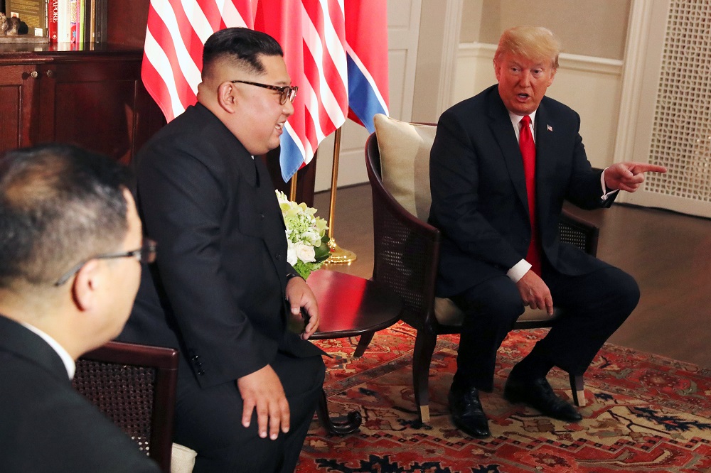 US President Donald Trump gestures next to North Korea's leader Kim Jong-un before their bilateral meeting at the Capella Hotel on Sentosa island in Singapore June 12, 2018. u00e2u20acu201d Reuters pic