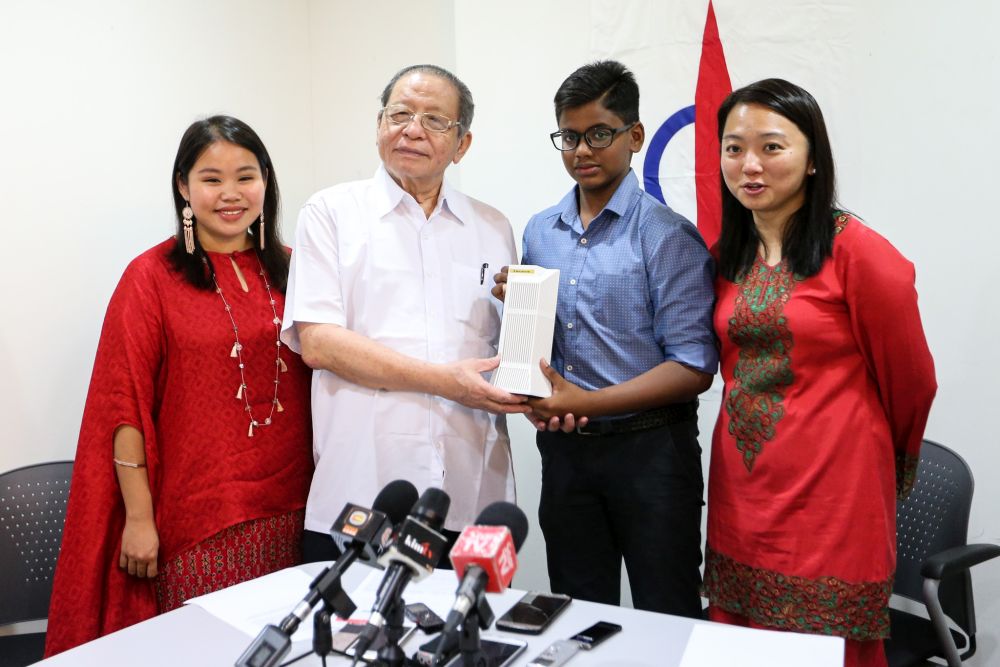 Instead of buying the drum set of his dreams, Ervin Devadason (second from right) chose to donate his savings over the past eight months to Tabung Harapan Malaysia. u00e2u20acu201d Picture by Ahmad Zamzahuri