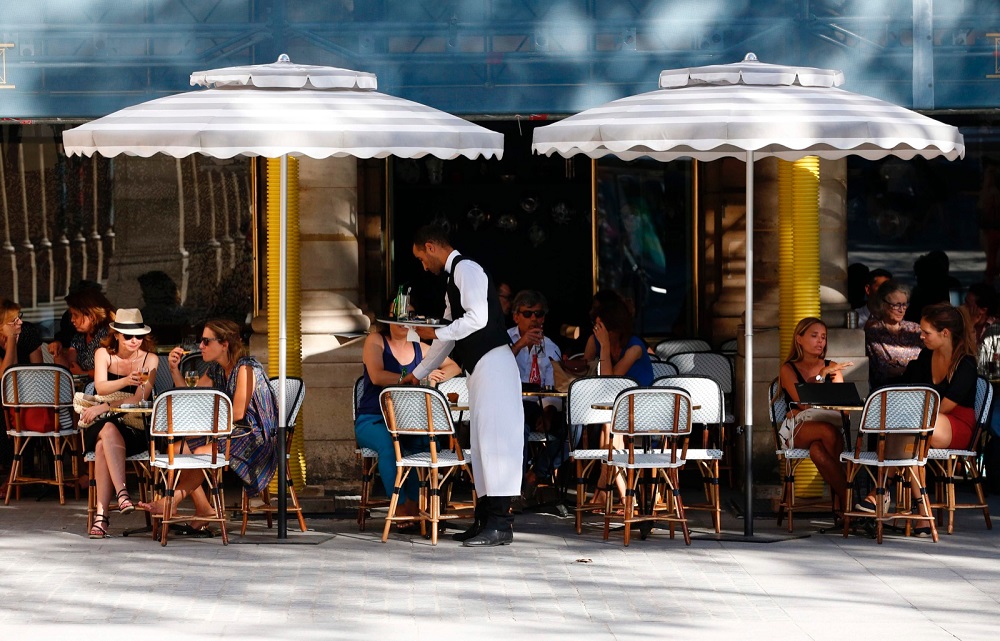 People sit on the outside sitting area of a cafe by the Jardin du Palais Royal in Paris August 23, 2016. u00e2u20acu201d AFP pic