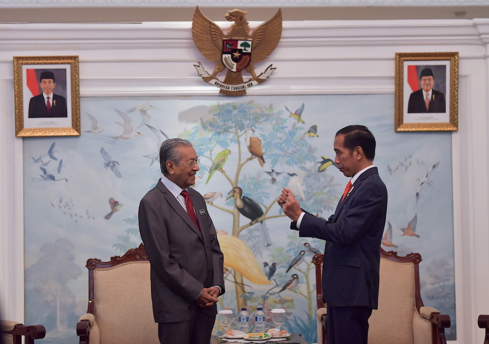 Prime Minister Tun Dr Mahathir Mohamad and Indonesian President Joko Widodo chat at Halim Perdanakusuma Airport in Jakarta June 28, 2018. u00e2u20acu201d Bernama pic