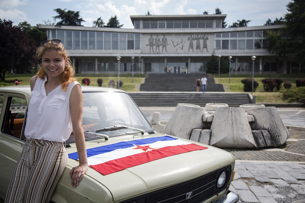Jovana Stojiljkovic, manager of the Yugotour agency, poses for a picture with a Yugoslav era popular car Zastava 101 on May 25, 2018, in front of the Museum of Yugoslavia in Belgrade. u00e2u20acu201d AFP pic 