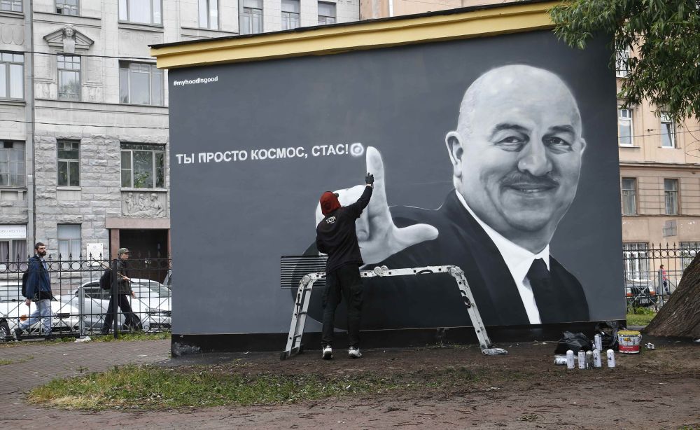 Ilya Is, a street artist from the Hoodgraff team, paints a graffiti art depicting Russia's national team coach Stanislav Cherchesov in central St Petersburg June 21, 2018. u00e2u20acu2022 Reuters pic