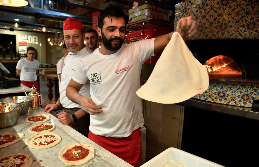 Pizza bakers prepare traditional pizza margherita at FICO Eataly World. u00e2u20acu201d AFP pic