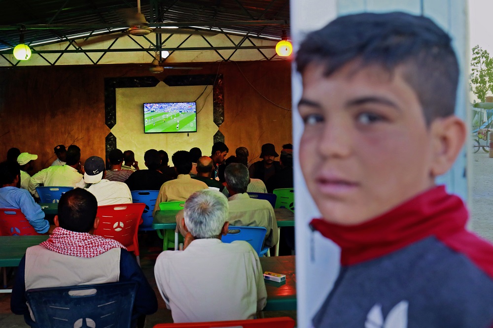 Displaced Syrians watch World Cup football match in Ain Issa camp in Raqqa province on June 17, 2018. u00e2u20acu201d AFP pic