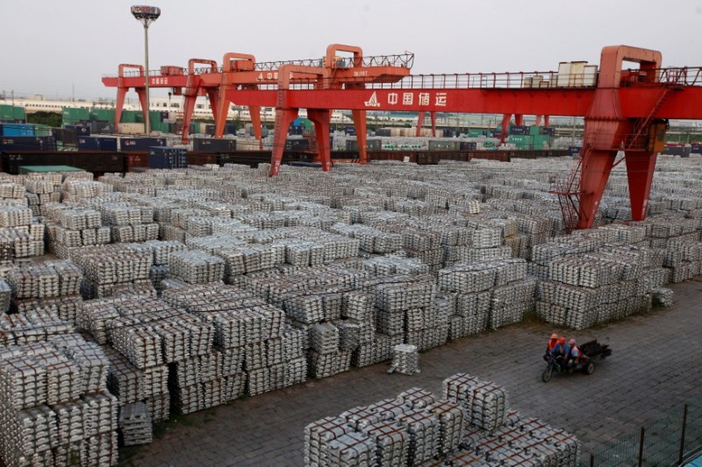 Workers ride on an motor rickshaw through an aluminium ingots depot in Wuxi, Jiangsu province September 26, 2012. u00e2u20acu201d Reuters pic