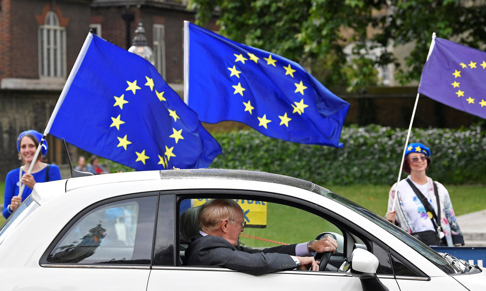 A motorist views anti-Brexit protesters outside of the Houses of Parliament in London June 13, 2018. u00e2u20acu201d Reuters pic