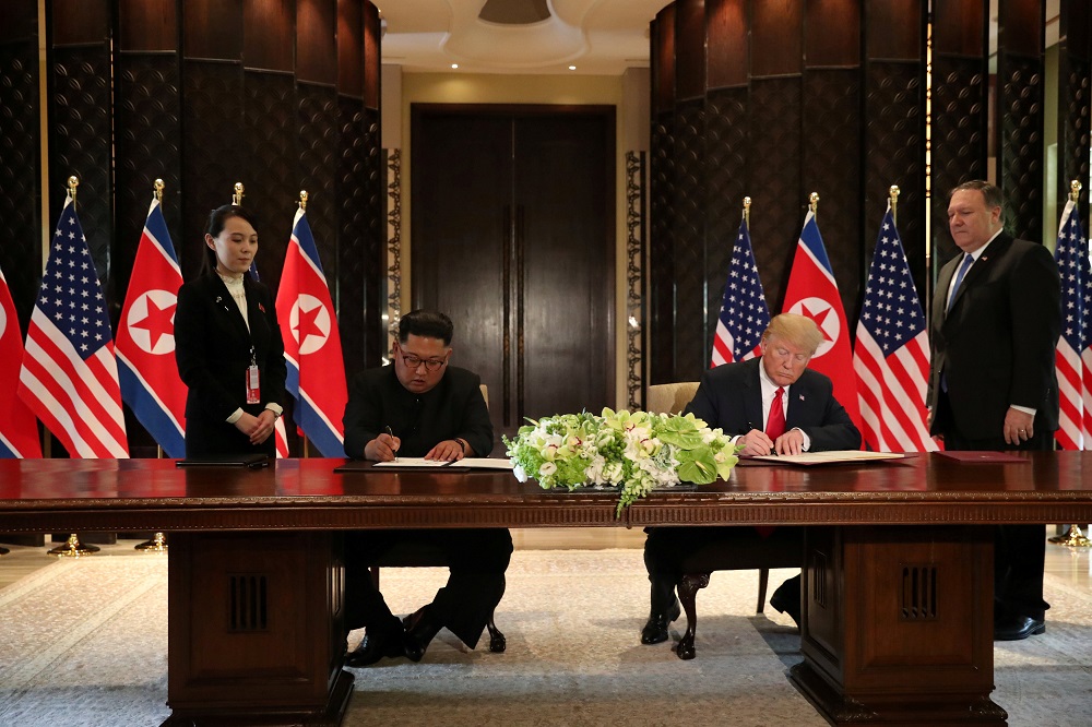 US President Donald Trump and North Korea's leader Kim Jong-un sign documents that acknowledge the progress of the talks and pledge to keep momentum going, after their summit at the Capella Hotel on Sentosa island in Singapore June 12, 2018