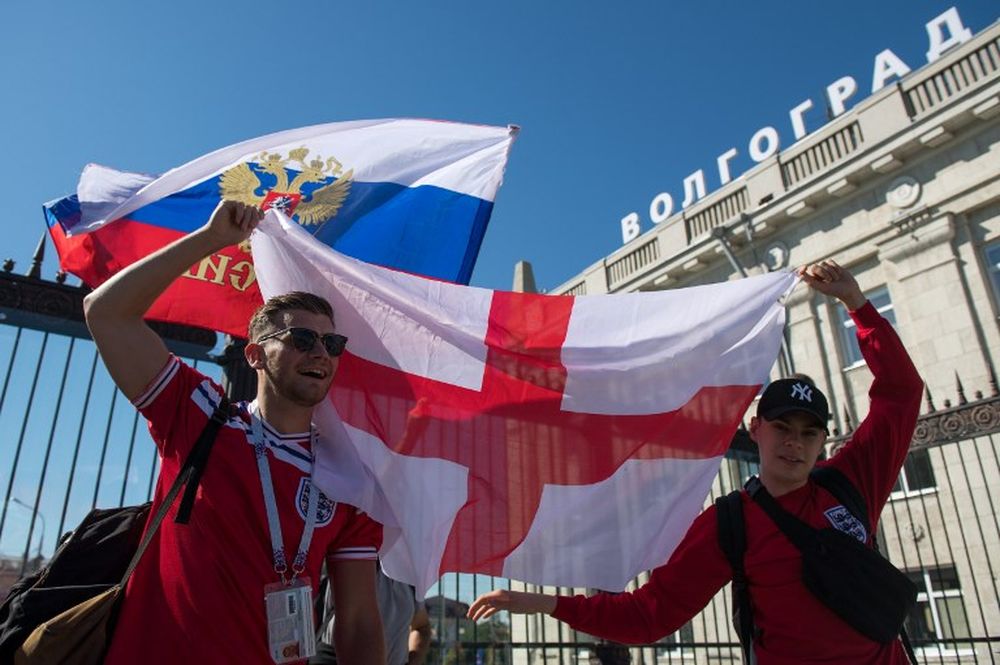 England football fans wave flags as they arrive at the Volgograd railway station in Volgograd, a city hosting several games of the Russia 2018 World Cup football tournament, on June 18, 2018. u00e2u20acu201d AFP pic