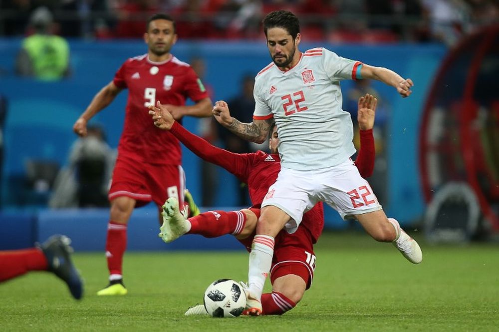 Spainu00e2u20acu2122s midfielder Isco (front) and Iranu00e2u20acu2122s forward Alireza Jahanbakhsh compete for the ball during the World Cup Group B match between Iran and Spain at the Kazan Arena in Kazan, Russia, June 20, 2018. u00e2u20acu201d AFP pic