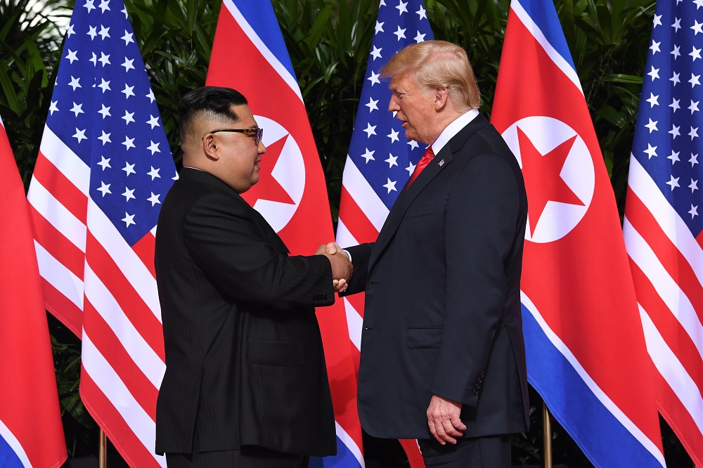 North Korea's leader Kim Jong-un shakes hands with US President Donald Trump at the start of their historic US-North Korea summit, at the Capella Hotel on Sentosa island in Singapore on June 12, 2018. u00e2u20acu201d AFP pic
