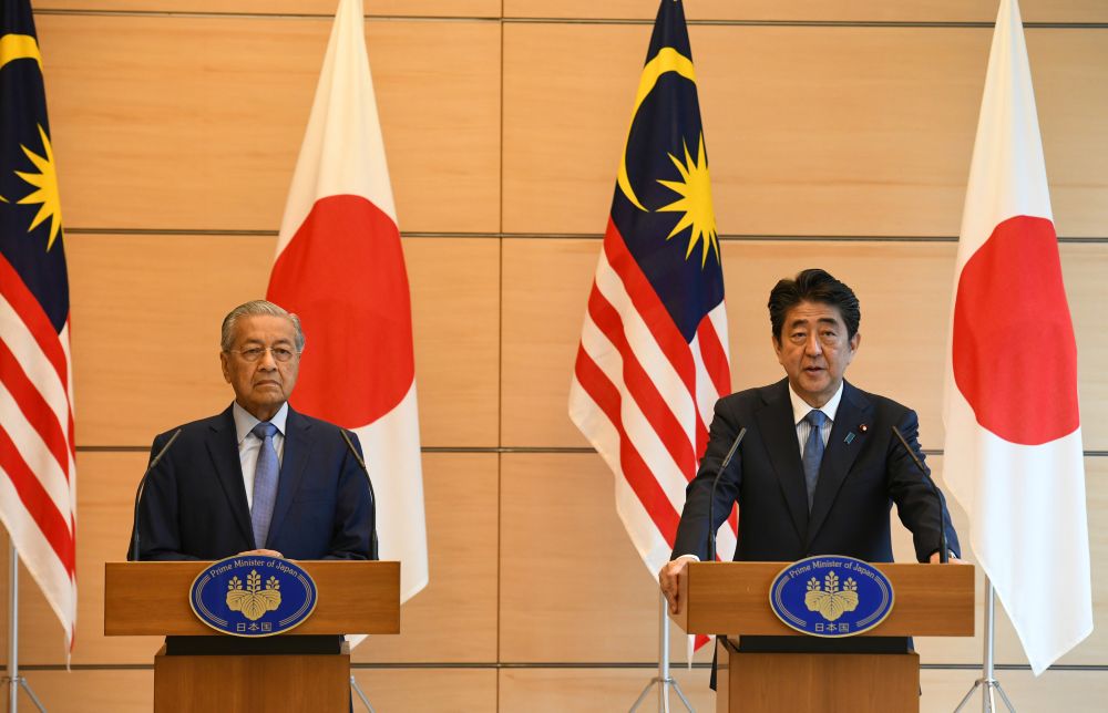 Malaysian Prime Minister Tun Dr Mahathir Mohamad delivers a speech beside his Japanese counterpart Shinzo Abe during their joint press remarks at Abe's official residence in Tokyo June 12, 2018. u00e2u20acu201d Reuters pic