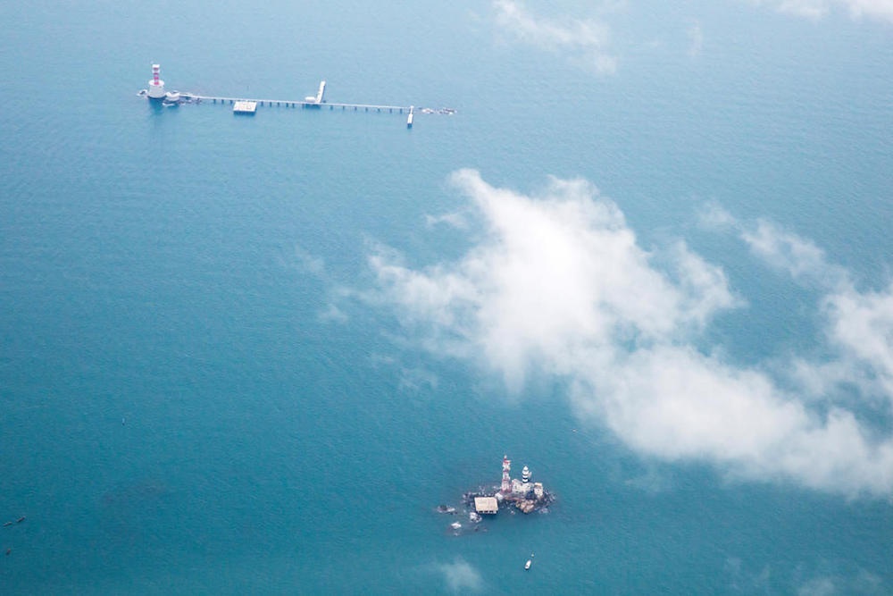 Malaysia has constructed a maritime base on Middle Rocks comprising a jetty linking the two main outcrops, a lighthouse and a helipad. The base lies close to Singaporeu00e2u20acu2122s Pedra Branca, which can be seen at the bottom of this photo. u00e2u20acu201d TODAY file pic