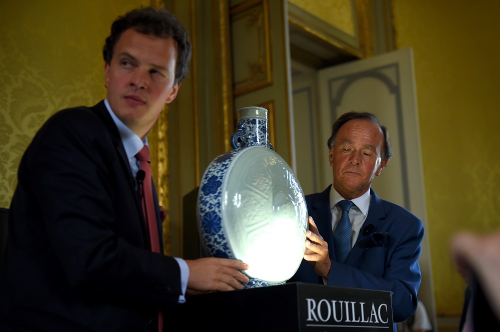 French auctioneer Aymeric (left) and Philippe Rouillac (right) hold a rare blue, white and celadon porcelain moon flask belonging to the emperor Qianlong is pictured during auction party on June 10, 2018 at the Artigny's castle in Montbazon. u00e2u20acu201d  AFP pic