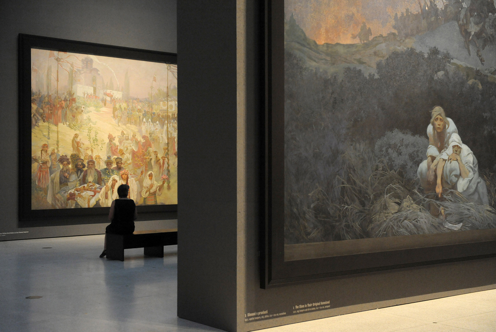 A visitor looks at the 'Slav Epic,' a cycle of 20 allegories tracing the history of the Slavic people and inspired in part by mythology. u00e2u20acu201d AFP picn