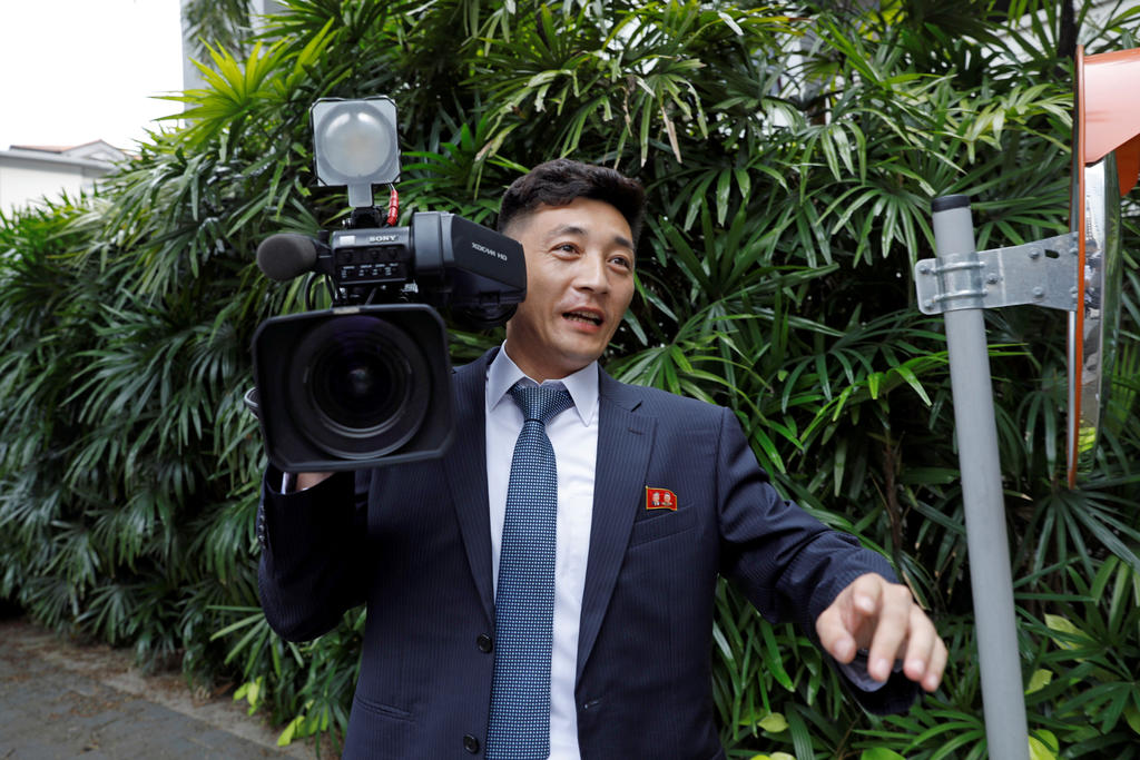 A North Korean cameraman reacts as he is chased by media outside St Regis hotel, ahead of the summit between the North Korean leader Kim Jong-un and US President Donald Trump, in Singapore June 10, 2018. u00e2u20acu201d Reuters pic