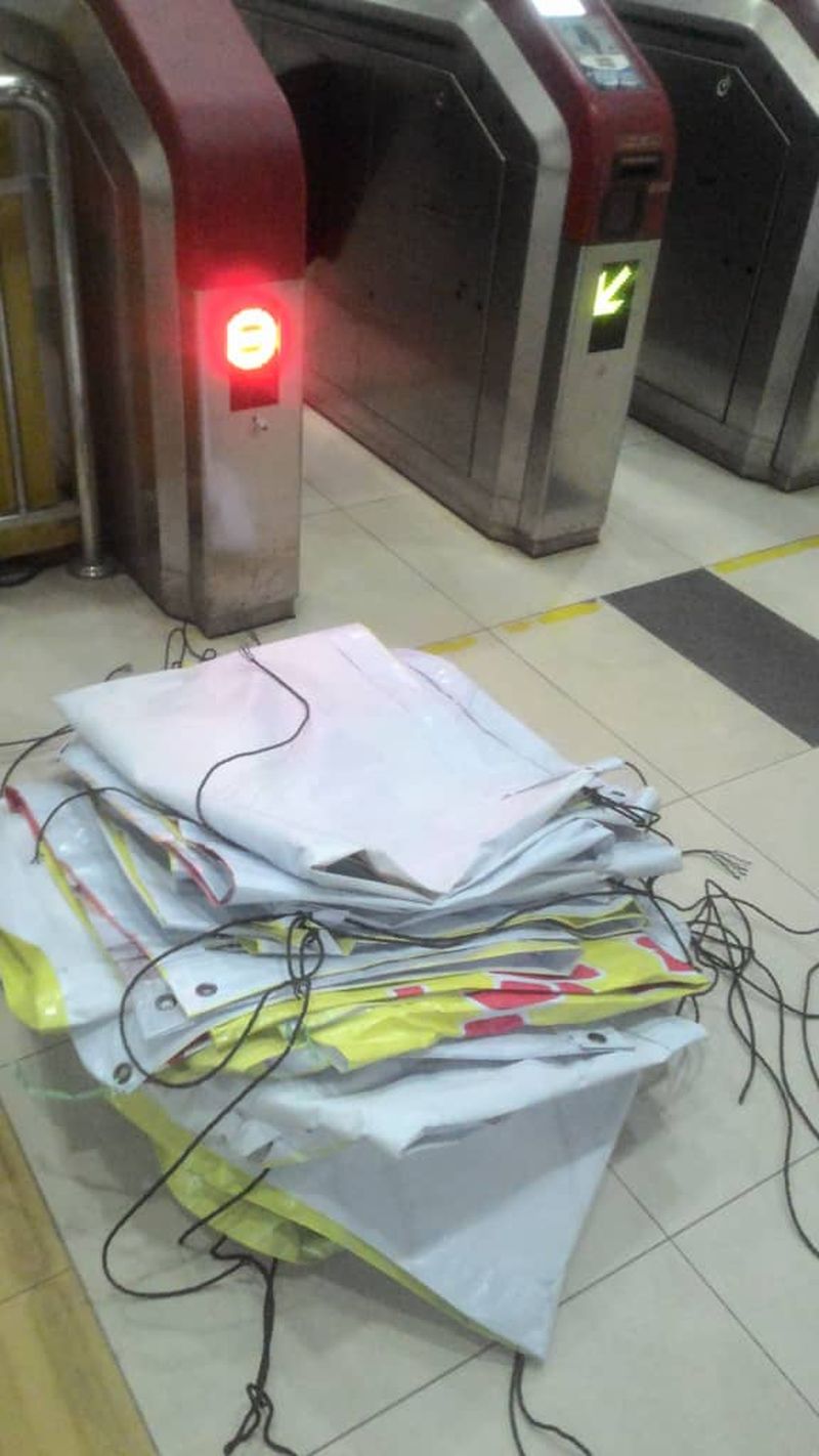 The removed banners are seen folded up near the ticket turnstiles.