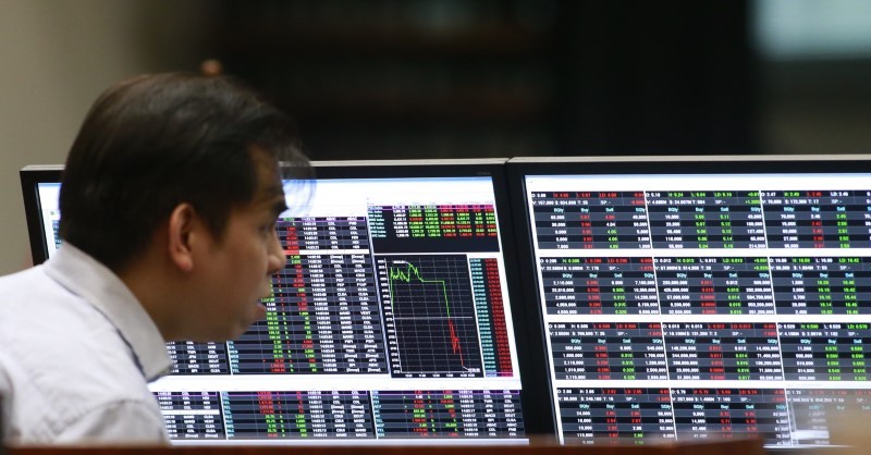 A stockbroker looks on his monitors inside the Philippine Stock Exchange (PSE) in Makati city, Manila February 29, 2016. u00e2u20acu201d Reuters pic
