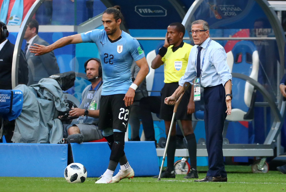 Uruguayu00e2u20acu2122s Martin Caceres prepares to take a free kick during their World Cup Group A against Russia as coach Oscar Tabarez looks on at Samara Arena, Samara June 25, 2018. u00e2u20acu201d Reuters pic