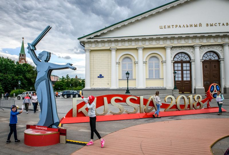 People walk among 2018 Fifa World Cup decorations set on Manezhnaya Square in downtown Moscow. u00e2u20acu2022 AFP pic