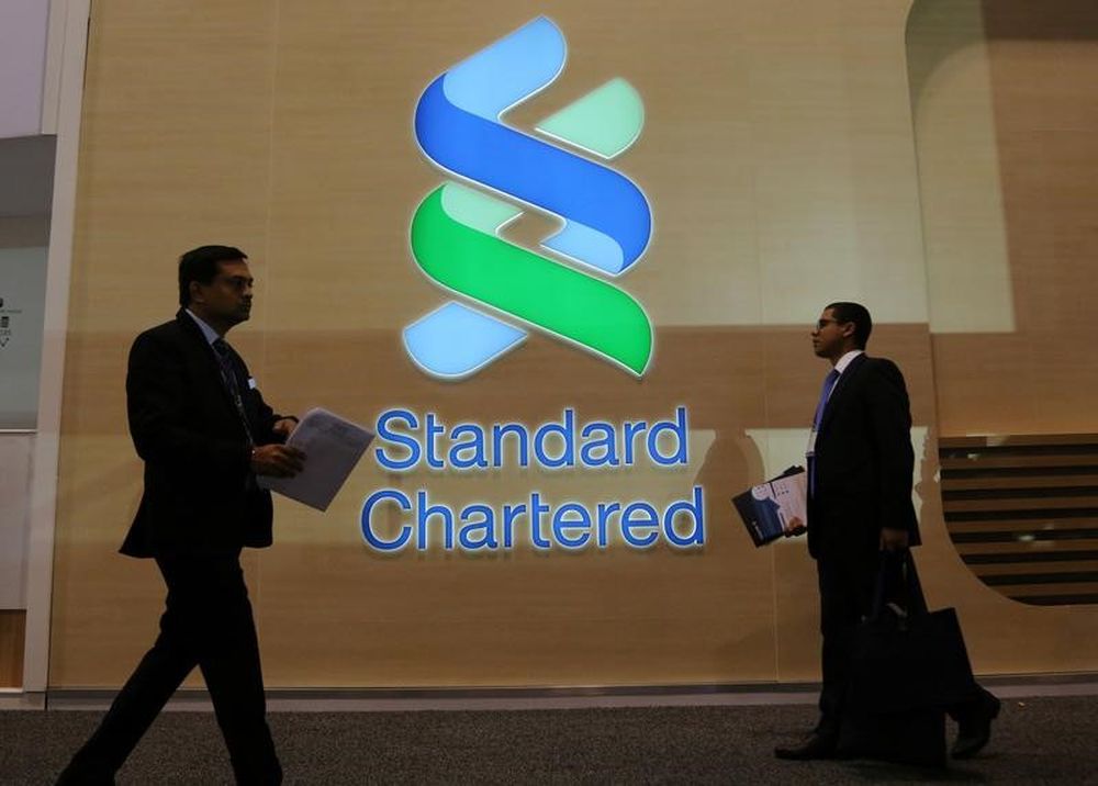 People pass by the logo of Standard Chartered plc at the SIBOS banking and financial conference in Toronto, Ontario, Canada October 19, 2017. u00e2u20acu201d Reuters pic