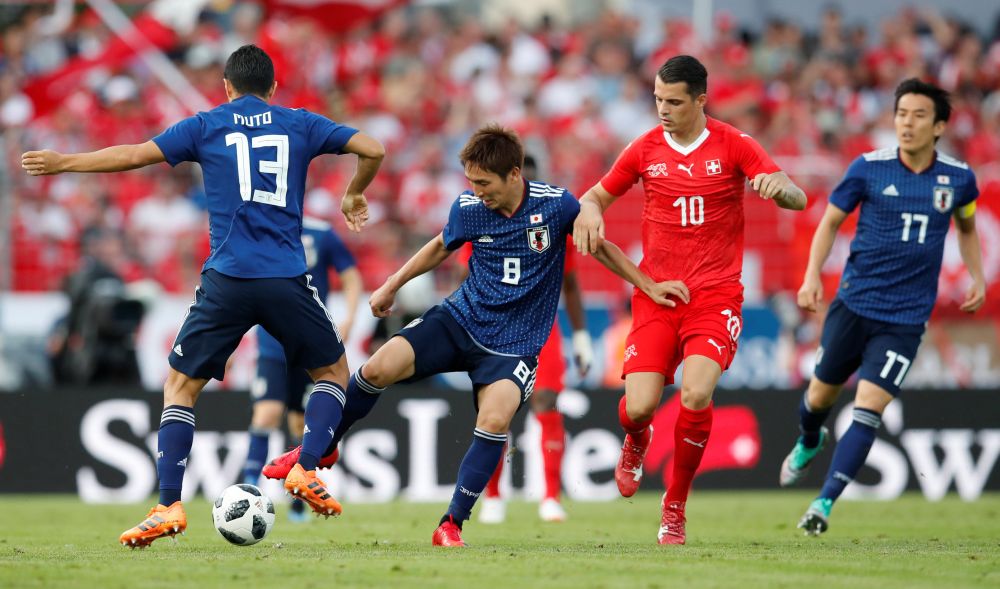 Japan's Genki Haraguchi in action with Switzerland's Granit Xhaka. u00e2u20acu2022 Reuters  pic