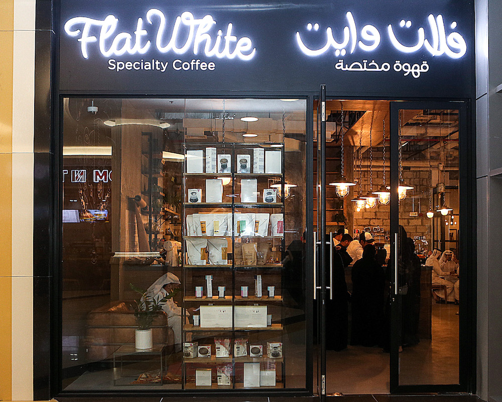 The exterior of the Flat White cafe with its neon-lit sign in the Qatari capital Dohau00e2u20acu2122s Tawar Mall June 8, 2018. u00e2u20acu201d AFP pic