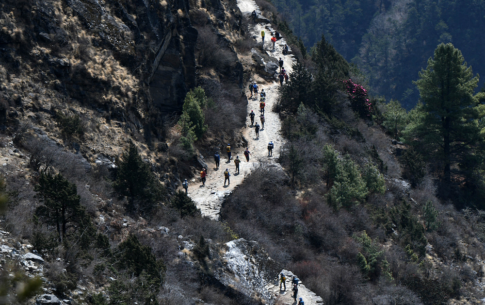 Trekkers and porters walk along a path in the Everest region, some 140 km northeast of Kathmandu. u00e2u20acu201d AFP pic