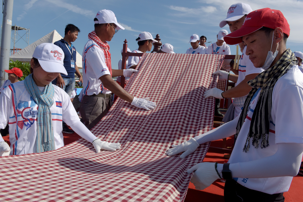 Cambodians roll out a 1,149.8 metre-long krama scarf so it can be declared as the world's longest hand woven scarf, in Phnom Penh today. u00e2u20acu201d AFP pic