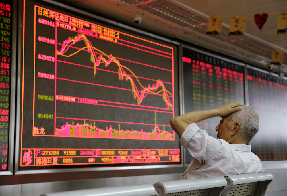 An investor looks at a board showing stock information at a brokerage office in Beijing July 6, 2018. u00e2u20acu201d Reuters pic