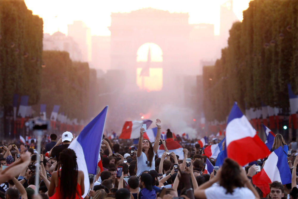 France fans celebrate on the Champs-Elysees avenue after France win the Football World Cup final against Croatia, July 16, 2018. u00e2u20acu201d Reuters pic