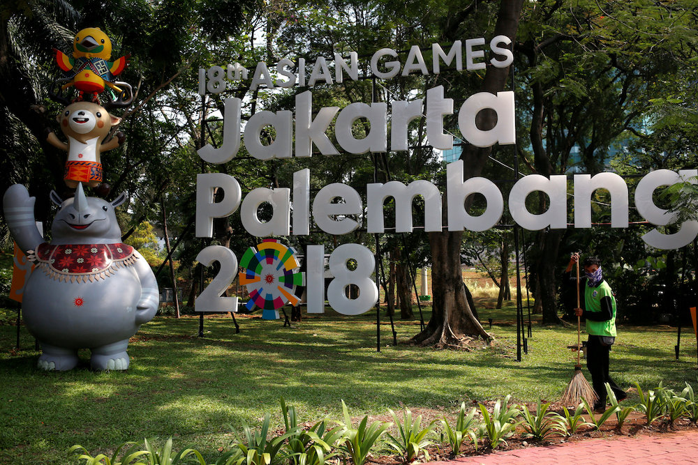 A worker cleans near a sign for the upcoming 2018 Asian Games, which would be held in both Jakarta and Palembang September 17, 2017. u00e2u20acu201d Reuters pic