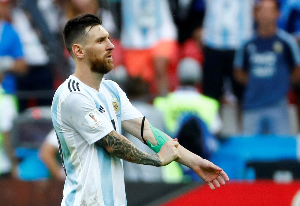 Argentina’s Lionel Messi looks dejected as he removes the captain’s armband after the match against France in Kazan, Russia June 30, 2018. 