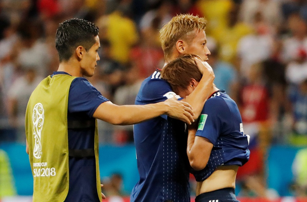 Japanu00e2u20acu2122s Takashi Inui is consoled by teammate Keisuke Honda after the match against Belgium at the Rostov Arena in Russia July 2, 2018. u00e2u20acu201d Reuters pic