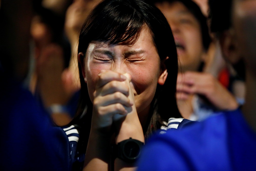 A Japanese fan reacts as she watches a broadcast of the World Cup Round of 16 soccer match Belgium vs Japan at a sports bar in Tokyo July 3, 2018. — Reuters pic