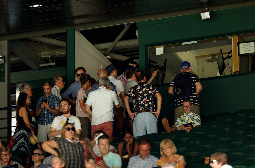 Spectators in the stands watch a TV screen, during the England vs Sweden match at the 2018 Fifa World Cup, on Centre Court at Wimbledon in London July 7, 2018. u00e2u20acu201d Reuters pic