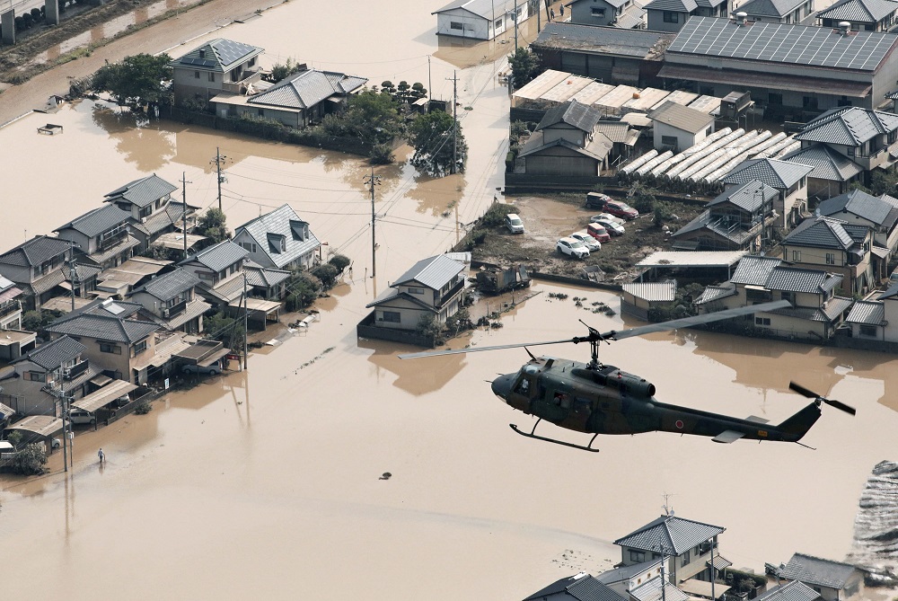 A helicopter flies over Mabi town which was flooded by the heavy rain in Kurashiki, Okayama Prefecture, Japan, in this photo taken by Kyodo July 9, u00e2u20acu201d Picture courtesy of Kyodo via Reuters