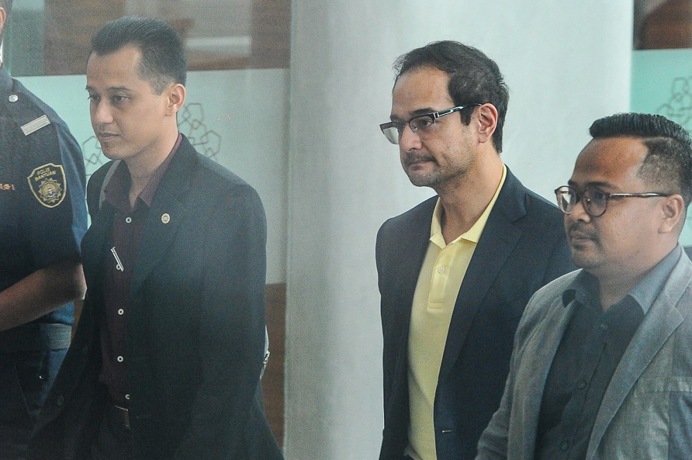 Datin Seri Rosmah Mansor's son, Riza Aziz (centre), arrives at the Malaysian Anti-Corruption Commissionu00e2u20acu2122s headquarters in Putrajaya July 3, 2018. u00e2u20acu201d Picture by Shafwan Zaidon