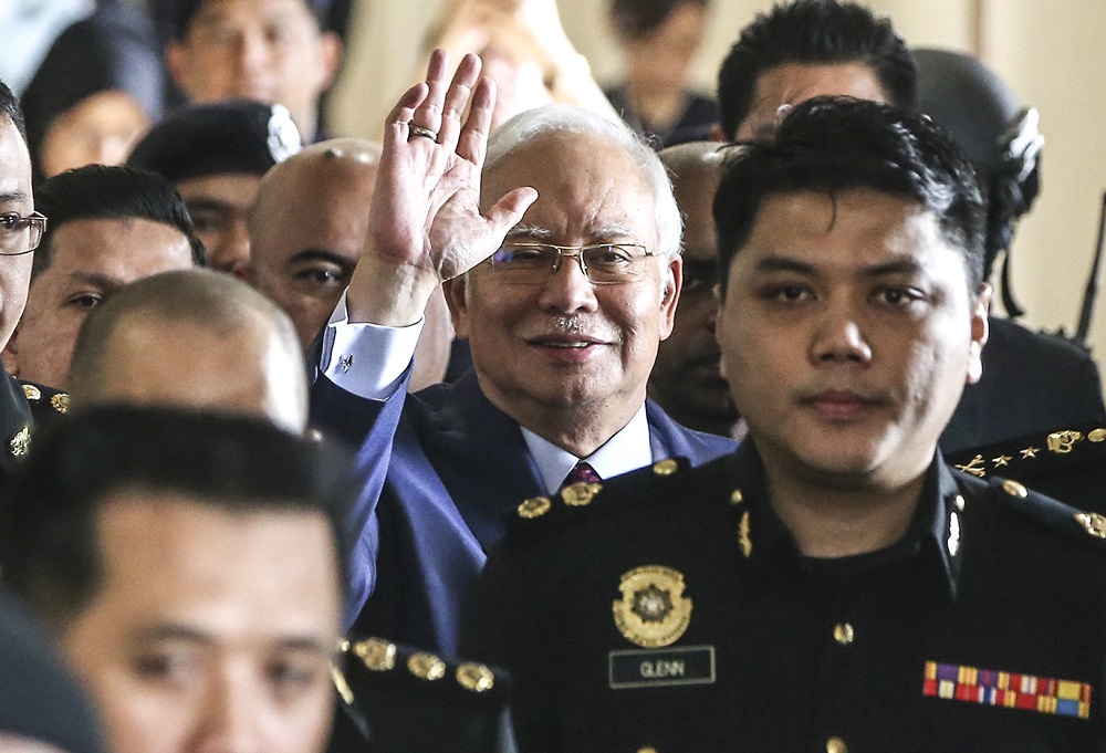 Former prime minister Datuk Seri Najib Razak waves at the media as arrives at the Kuala Lumpur Courts Complex July 4, 2018. — Picture by Azneal Ishak 