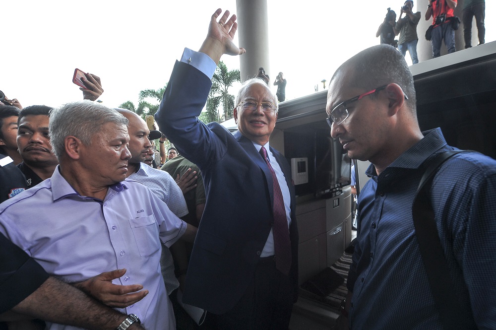 Former prime minister Datuk Seri Najib Razak waves at the crowd as he leaves the Kuala Lumpur Courts Complex July 4, 2018. u00e2u20acu201d Picture by Shafwan Zaidon