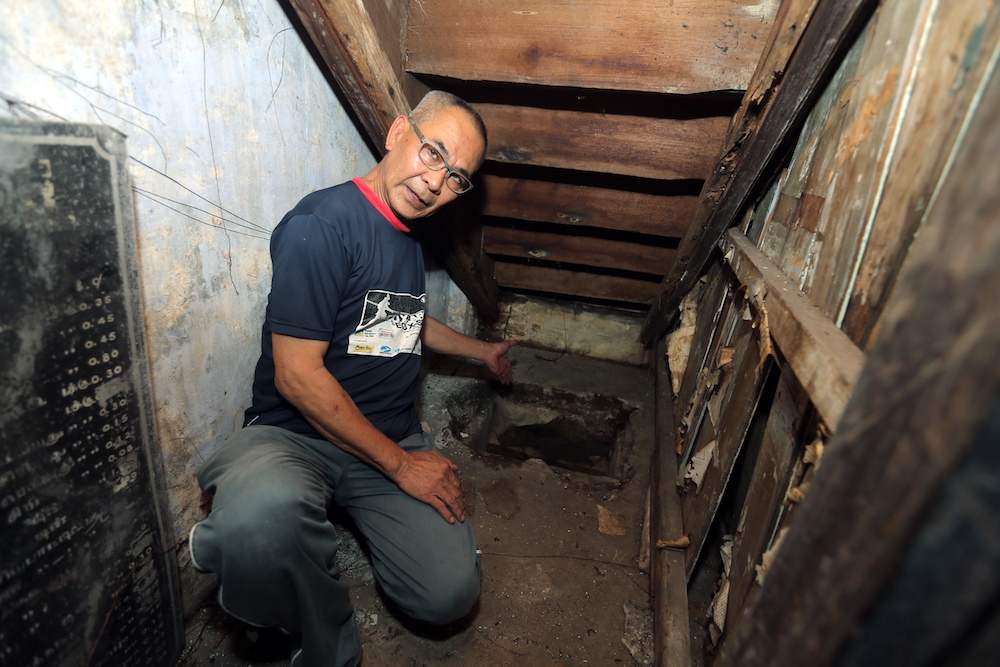 Law points to the hole where a shortwave radio was hidden by Sybil Kathigasu during the Japanese Occupation. — Picture by Farhan Najib