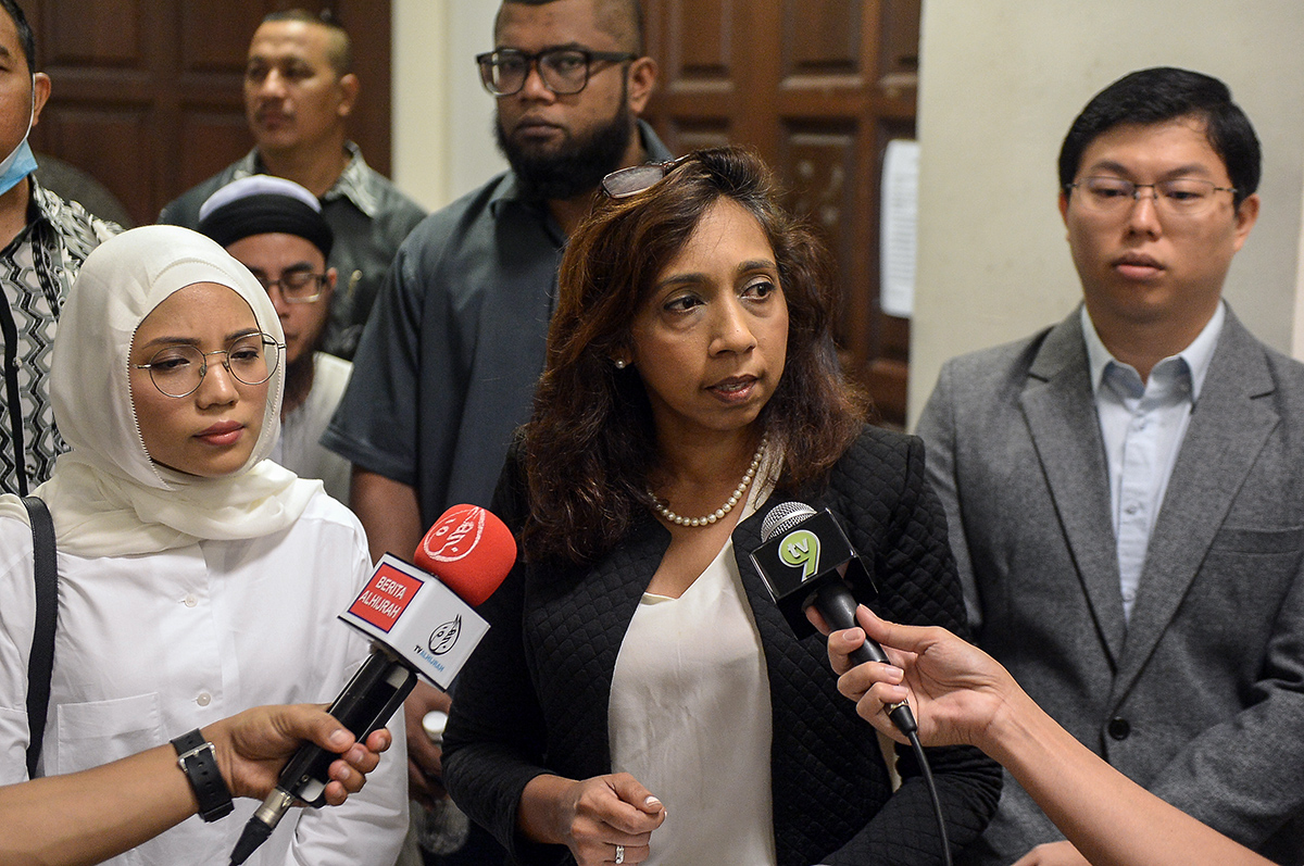 Sharmila Sekaran speaks to journalists outside the Magistrates’ Court with Maya Ahmad Fuaad (left) and Women’s Aid Organisation (WAO) acting executive director, Yu Ren Chung, at the Shah Alam court complex July 13, 2018. — Picture by Mukhriz Hazim 