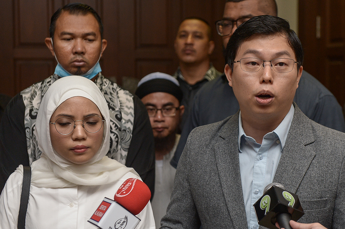 Womenu00e2u20acu2122s Aid Organisation (WAO) acting executive director, Yu Ren Chung, with Maya Ahmad Fuaad (left), speaks to journalists outside the Magistratesu00e2u20acu2122 Court at the Shah Alam court complex July 13, 2018. u00e2u20acu201d Picture by Mukhriz Hazim 
