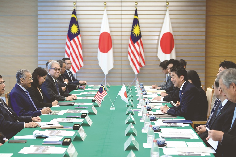 Prime Minister Tun Dr Mahathir Mohamad (left) in discussion with his Japanese counterpart Shinzo Abe in Tokyo on June 12. The writer says Malaysia’s foreign policy has shifted under successive prime ministers and since the creation of the new government, many diplomats have asked what Malaysia’s foreign policy will look like. — Picture by Bernama