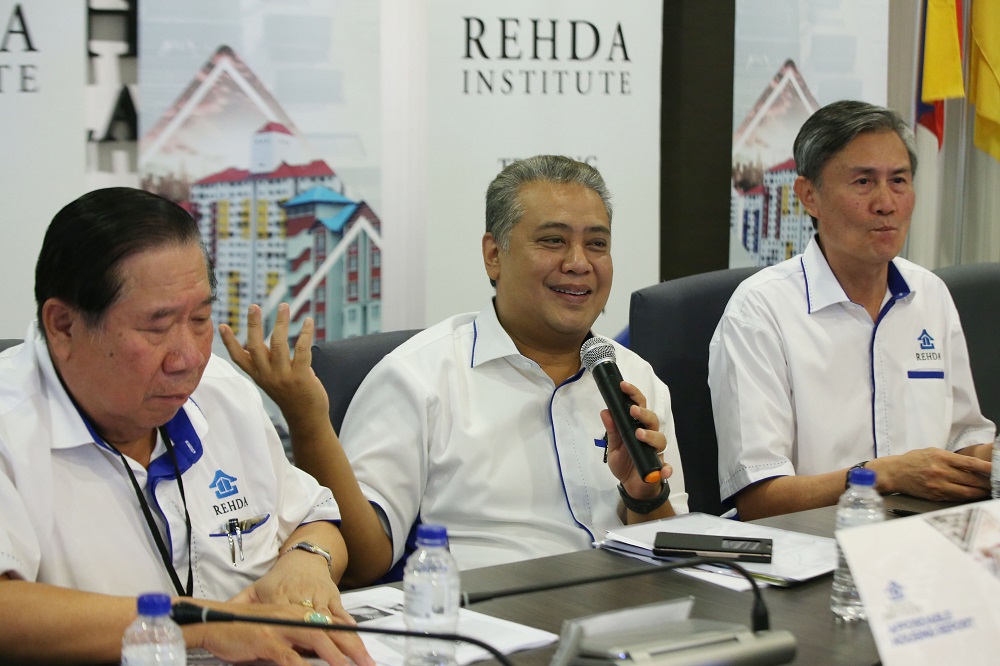 Rehda president Datuk Seri Fateh Iskandar (centre) and chairman Datuk Jeffrey Ng Tiong Lip (right) at a press conference in Petaling Jaya July 14, 2018. u00e2u20acu201d Picture by Azinuddin Ghazali