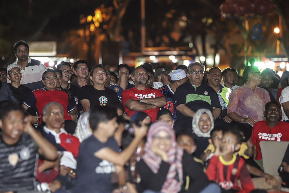 Communications and Multimedia Minister Gobind Singh Deo (centre, standing) watches the Fifa World Cup 2018 final match between France and Croatia at Dataran MPSJ in Puchong July 15, 2018. — Picture by Azneal Ishak