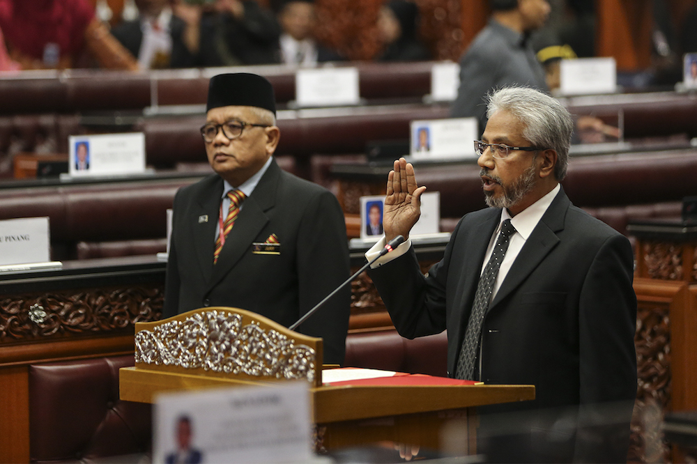 P. Waytha Moorthy takes his oath before Dewan Negara Speaker Tan Sri SA Vigneswaran at Parliament in Kuala Lumpur July 17, 2018. u00e2u20acu2022 Picture by Azneal Ishak