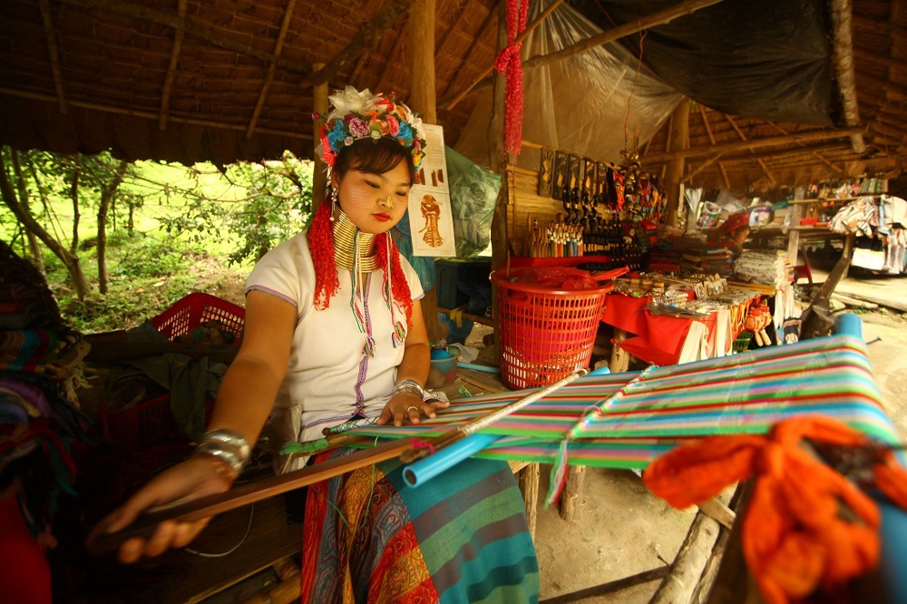 A Karen hill tribe woman weaves a scarf using traditional equipment at a village in Thailand. u00e2u20acu201d Picture by Hommeang Mongkorn