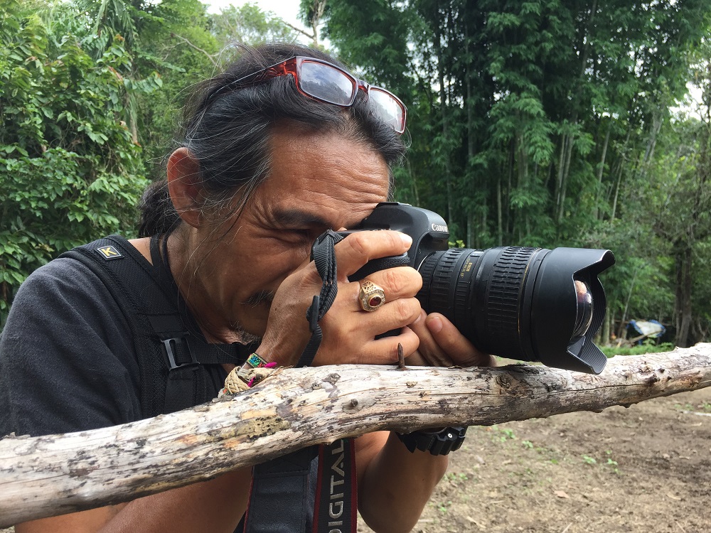 Tour guide and amateur photographer Hommeang Mongkorn busy doing what he does best. — Picture by Chris Mohan
