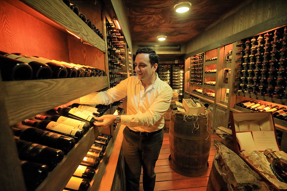 Banjaran Hotsprings Retreat general manager Alex Castaldi shows off Sunway Group founder Tan Sri Jeffery Cheah’s wine cellar, which houses over 2,000 bottles of his prized collection. — Picture by Marcus Pheong