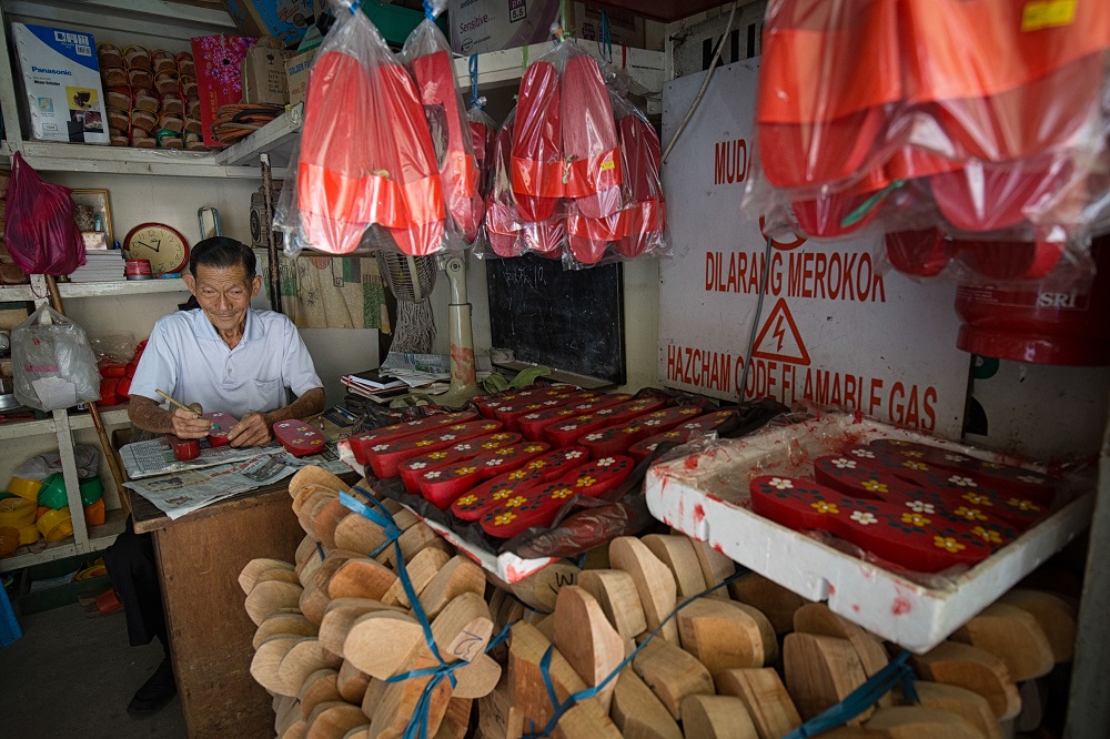 Cheah’s shop, located on the ground floor of a four-storey building in Jalan Silang, Ipoh, is adorned with red clogs, typically used in Chinese weddings and important occasions.
